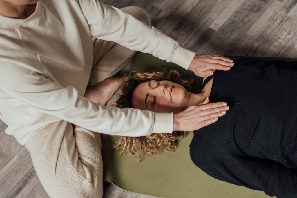 Woman in White Long Sleeve Shirt Lying on Bed